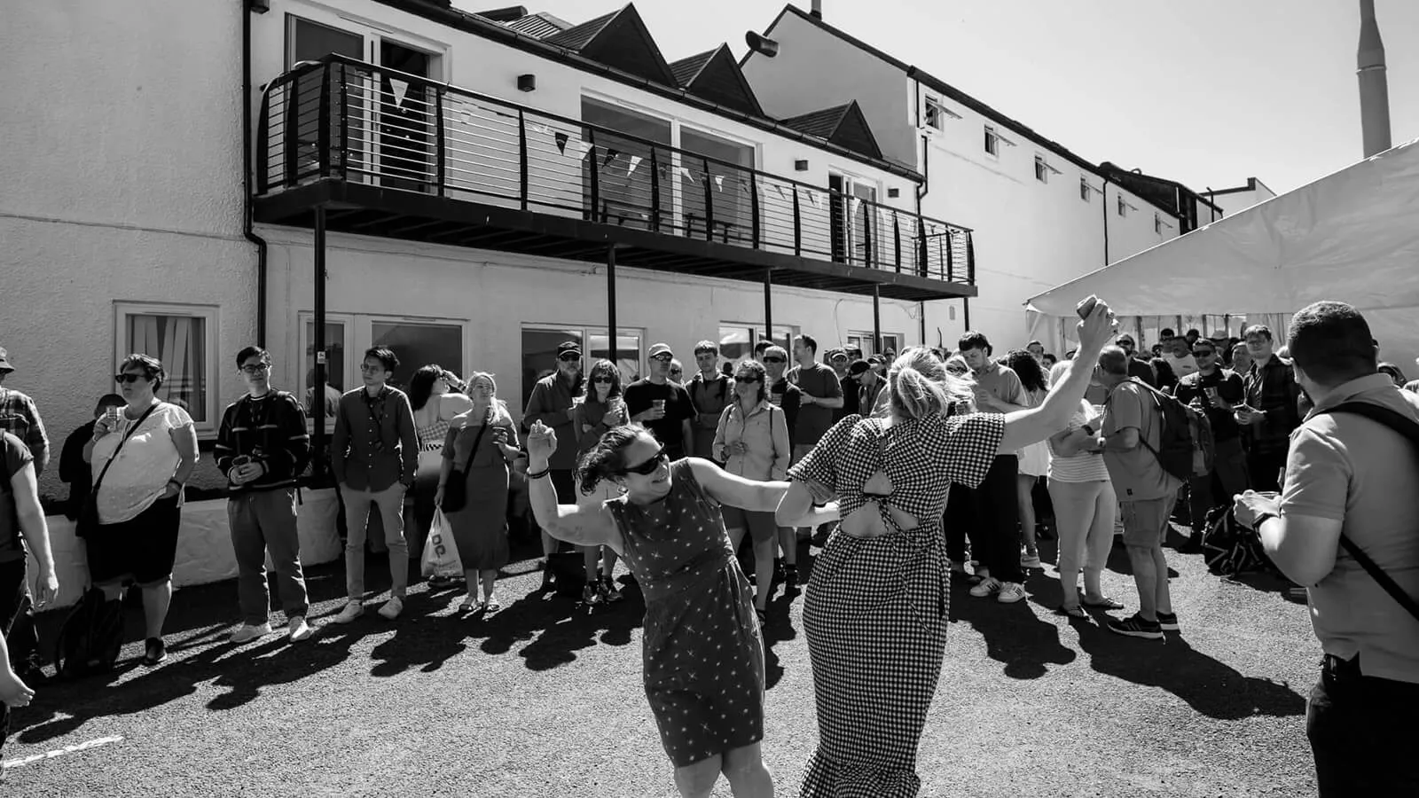 Black and white still of people dancing from the Feis Ile festival