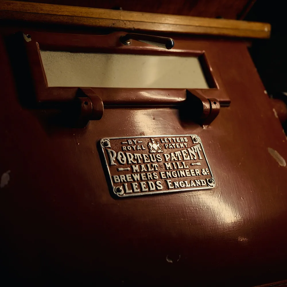 Malt mill at Islay distillery with name-plate.