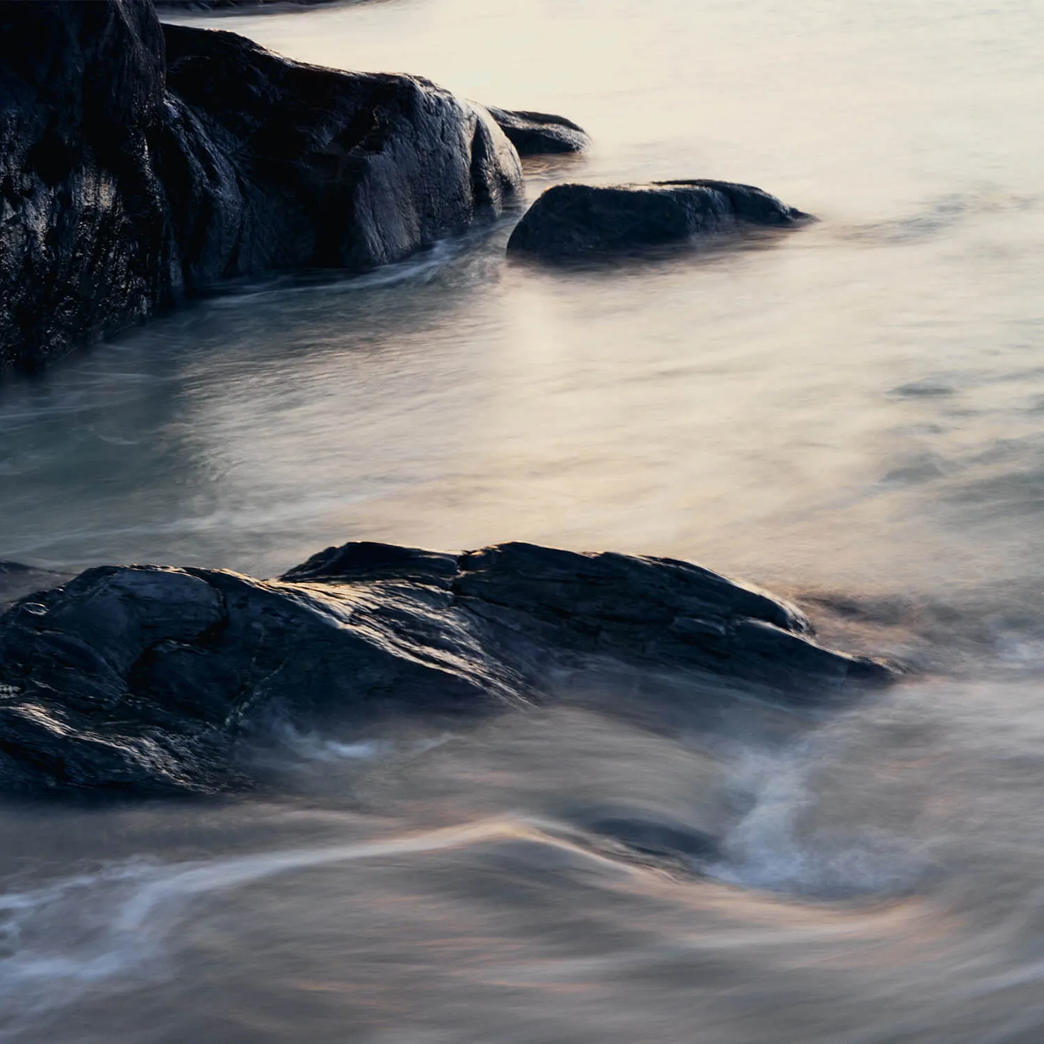 Swirling-sea-against-black-coastal-Islay-rock