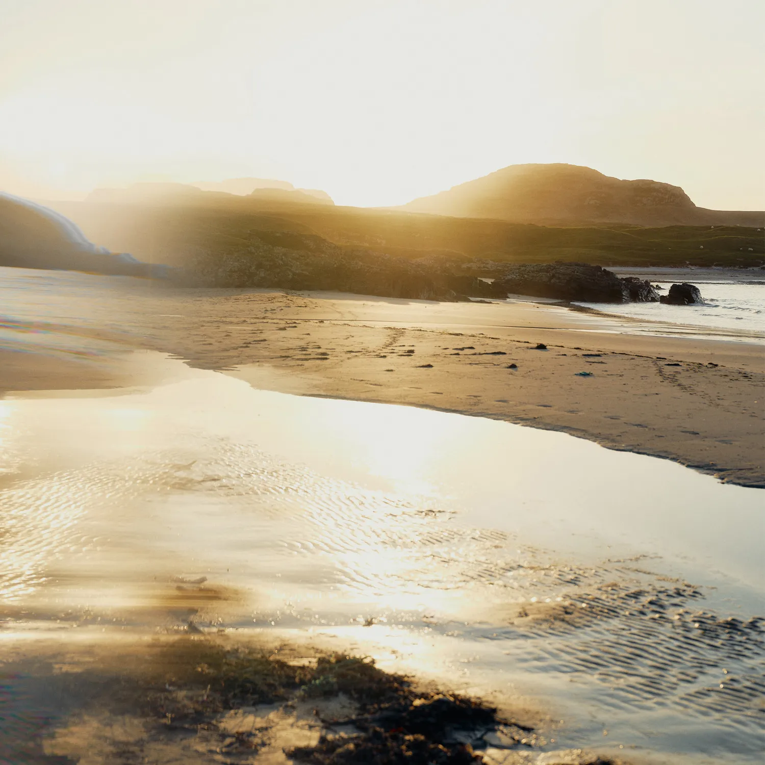 Sunset beach at Islay distillery with horizon