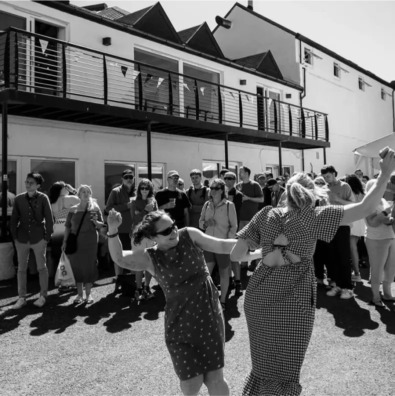 Black and white still of people dancing from the Feis Ile festival