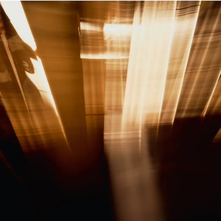 Close-up-light-shining-through-wooden-beams.
