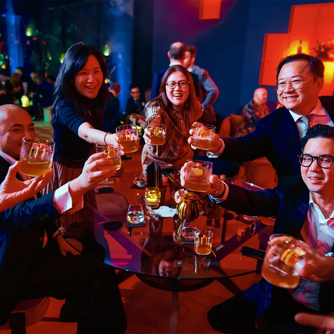 A group of event attendees celebrating with their Bowmore drams and serves