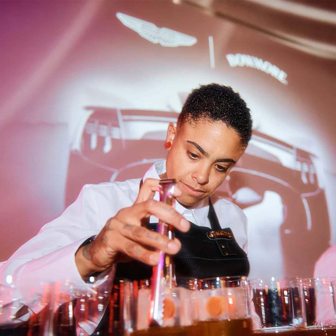 Bartender mixing Bowmore drinks at the event bar at Raffles in London