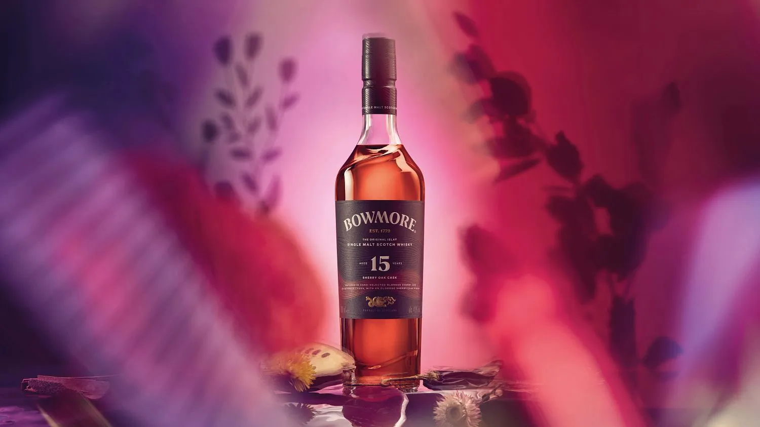 Bottle of Bowmore 15 Year Old Sherry Oak Cask surrounded by tropical fruits
